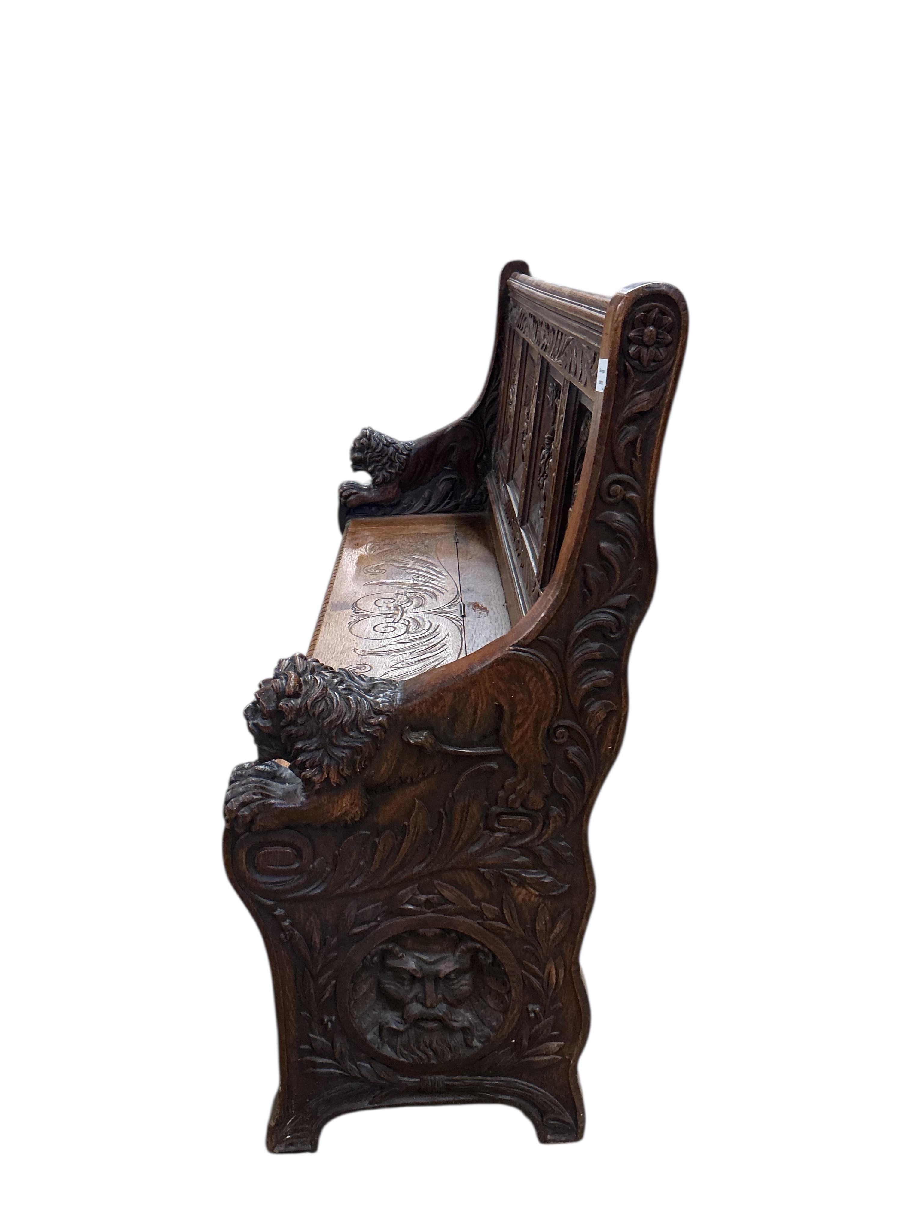 A late 19th century Flemish carved oak settle with hinged box seat, width 160cm, depth 42cm, height 106cm